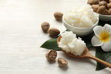 Photo of Natural shea butter on white wooden table, closeup. Space for text