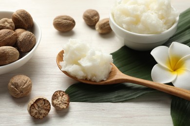 Photo of Natural shea butter on white wooden table, closeup