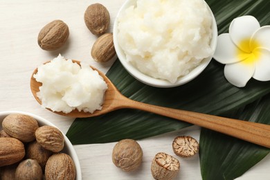 Photo of Natural shea butter on white wooden table, flat lay