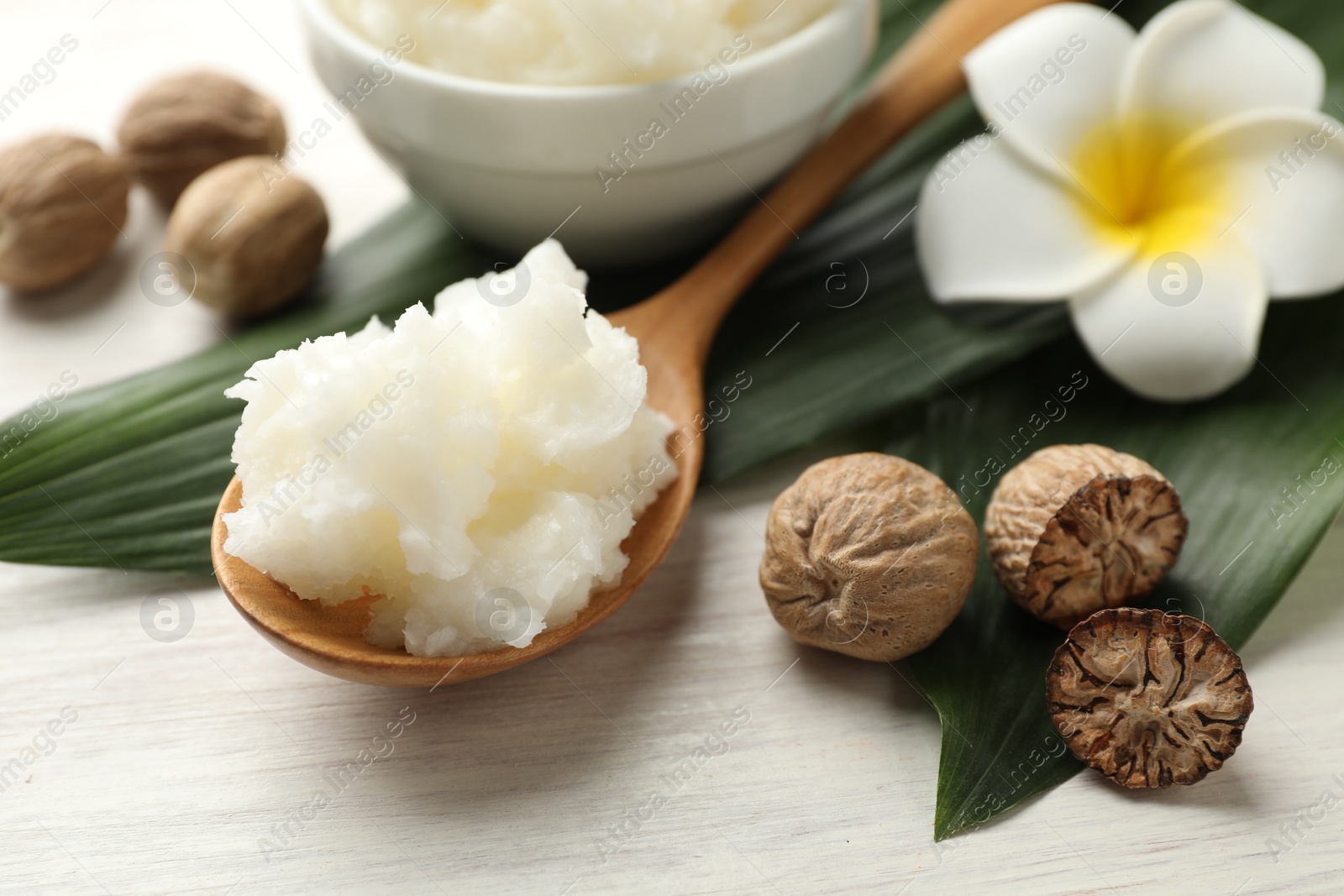Photo of Natural shea butter on white wooden table, closeup