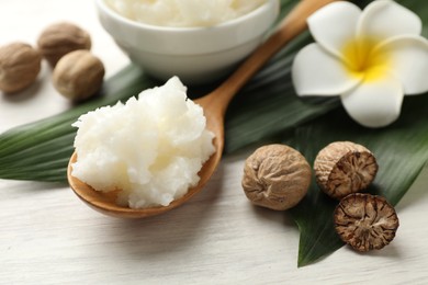 Photo of Natural shea butter on white wooden table, closeup