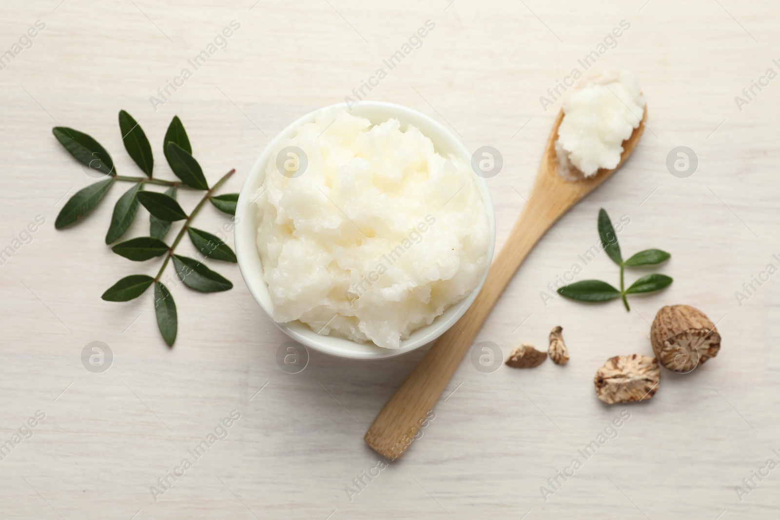Natural shea butter on white wooden table, flat lay Photo of Natural shea butter on white wooden table, flat lay