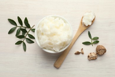 Photo of Natural shea butter on white wooden table, flat lay