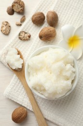 Photo of Natural shea butter on white wooden table, flat lay