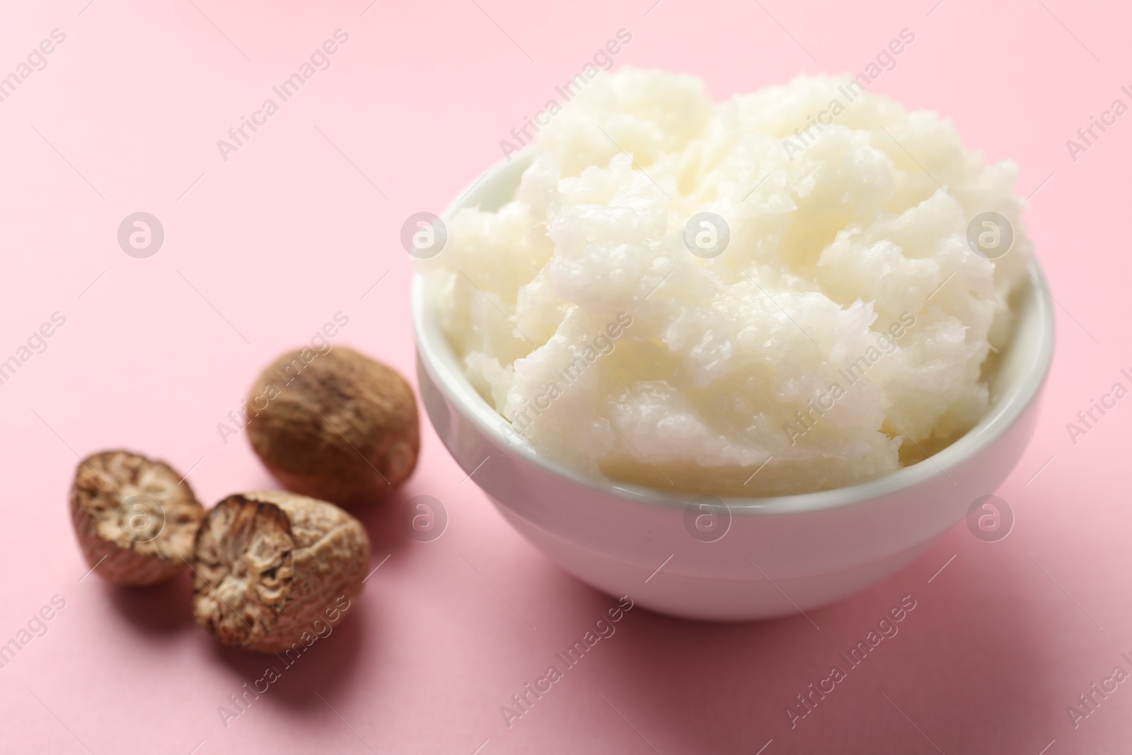 Natural shea butter on pink background, closeup Photo of Natural shea butter on pink background, closeup