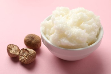 Photo of Natural shea butter on pink background, closeup