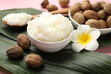 Photo of Natural shea butter on pink background, closeup