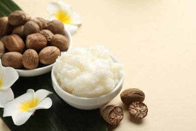 Photo of Natural shea butter on beige background, closeup. Space for text