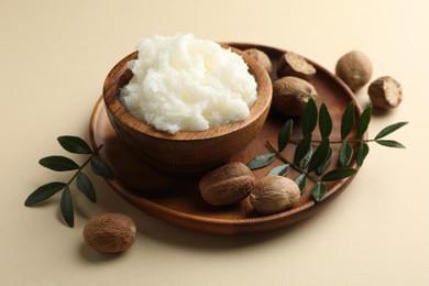 Photo of Natural shea butter on beige background, closeup