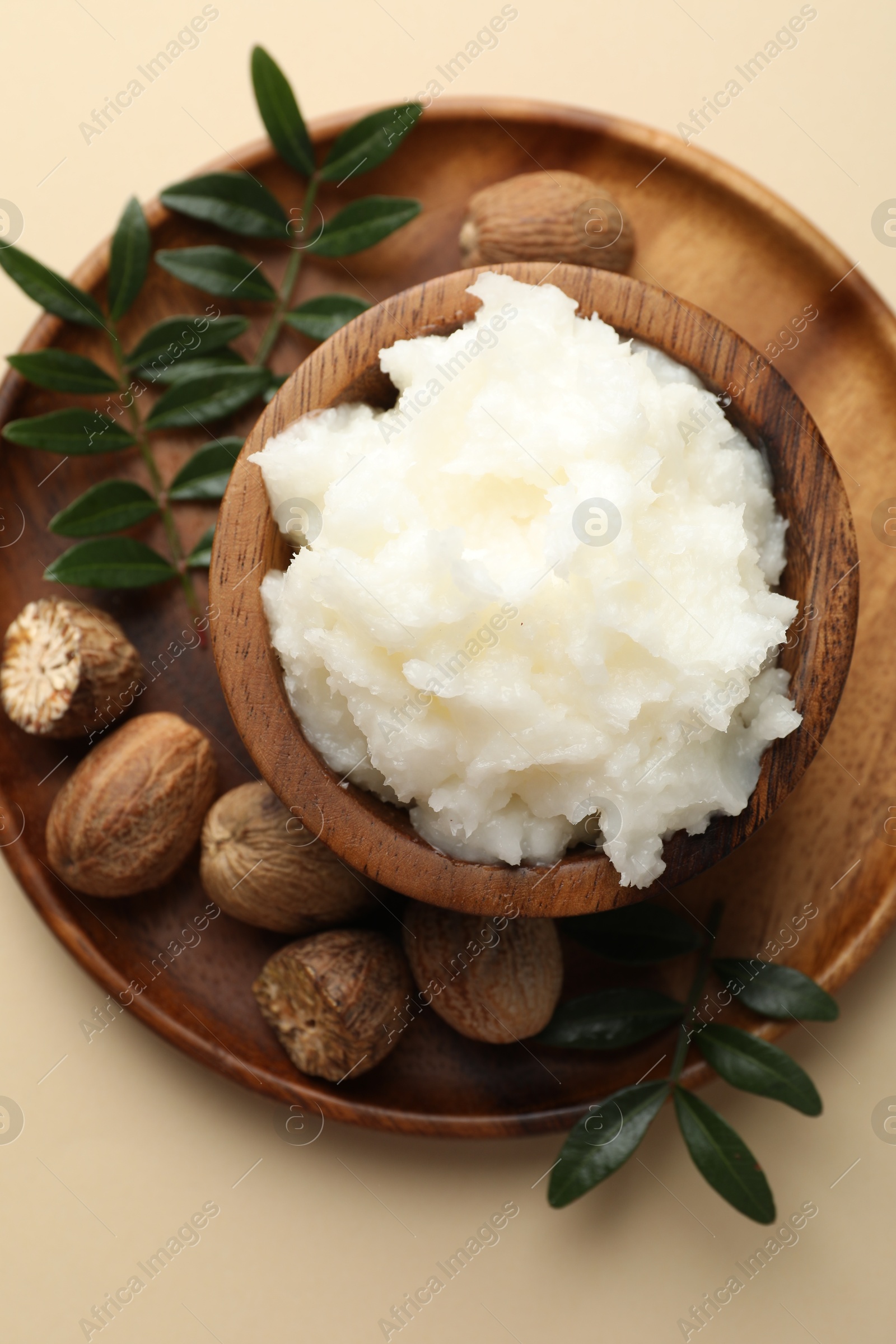 Natural shea butter on beige background, top view Photo of Natural shea butter on beige background, top view