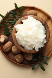 Photo of Natural shea butter on beige background, top view