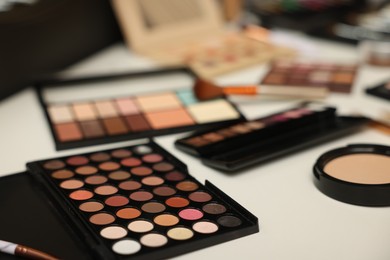 Photo of Different makeup products on dressing table indoors, closeup
