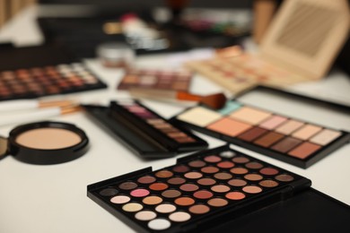 Photo of Different makeup products on dressing table, closeup