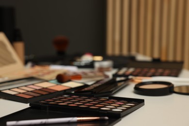 Photo of Different makeup products on dressing table indoors, closeup