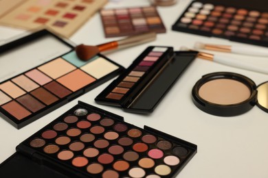 Photo of Different makeup products on dressing table, closeup