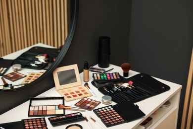 Photo of Different makeup products on dressing table indoors, above view