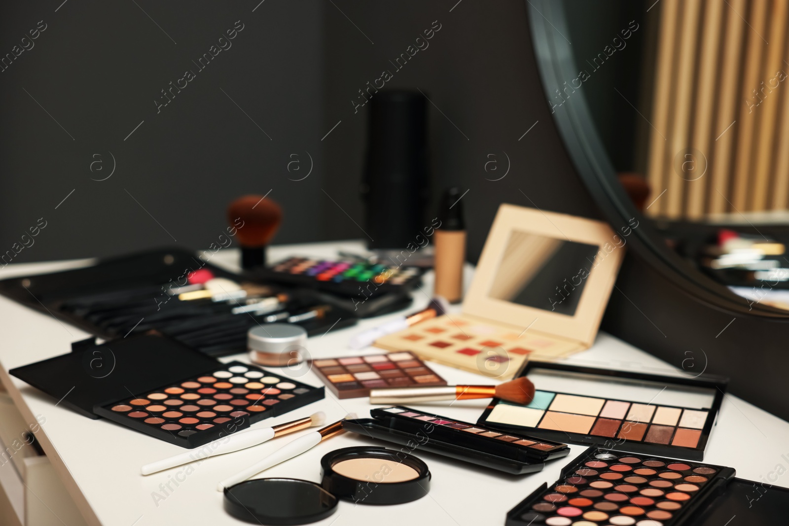 Different makeup products on dressing table indoors, closeup Photo of Different makeup products on dressing table indoors, closeup