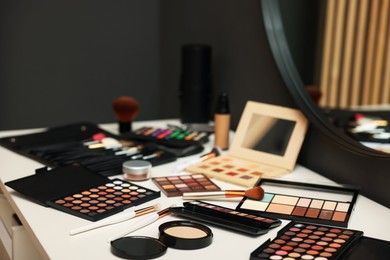 Photo of Different makeup products on dressing table indoors, closeup