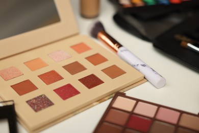 Photo of Different makeup products on dressing table, closeup