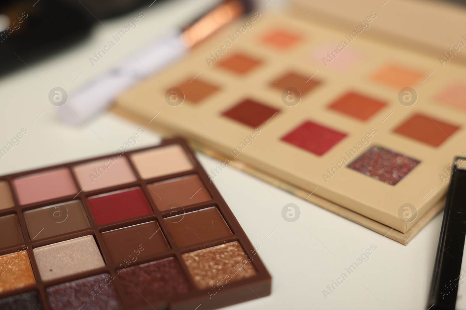 Photo of Different makeup products on dressing table, closeup