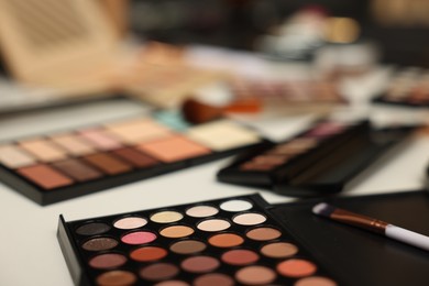 Photo of Different makeup products on dressing table, closeup