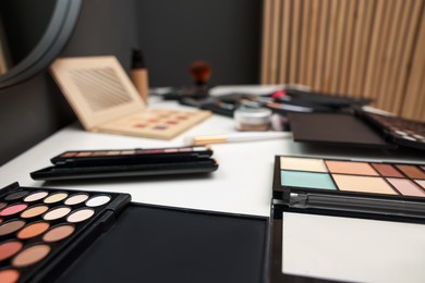 Photo of Different makeup products on dressing table indoors, closeup