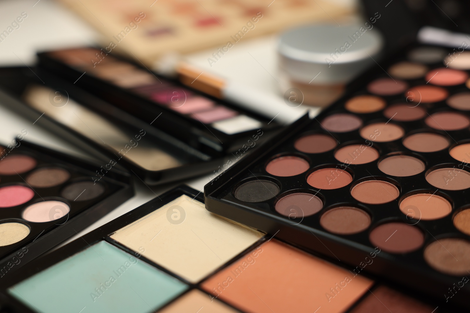Different makeup products on dressing table indoors, closeup Photo of Different makeup products on dressing table indoors, closeup