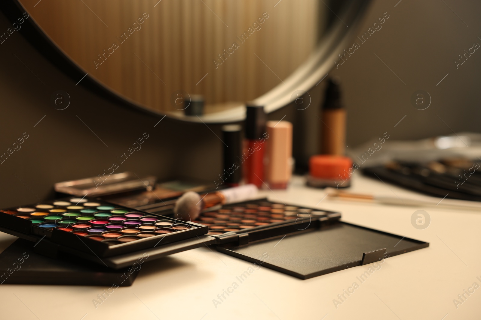 Photo of Different makeup products on dressing table indoors, closeup