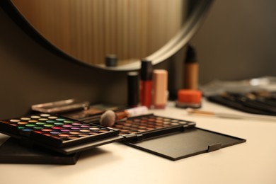 Photo of Different makeup products on dressing table indoors, closeup