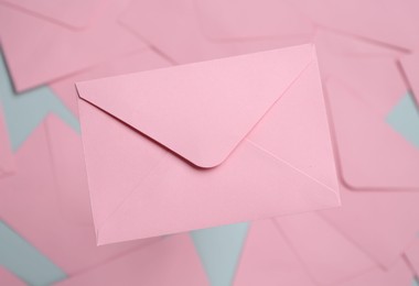 Photo of Beautiful invitation envelope on glass surface, top view