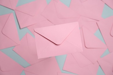 Photo of Beautiful invitation envelope on glass surface, top view