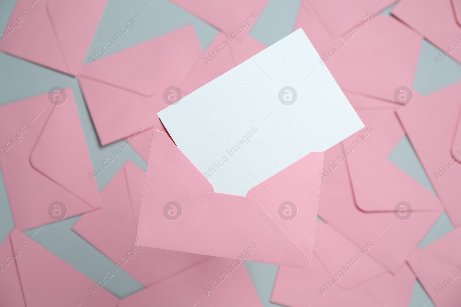 Blank invitation card and envelope on glass surface, top view. Space for design Photo of Blank invitation card and envelope on glass surface, top view. Space for design