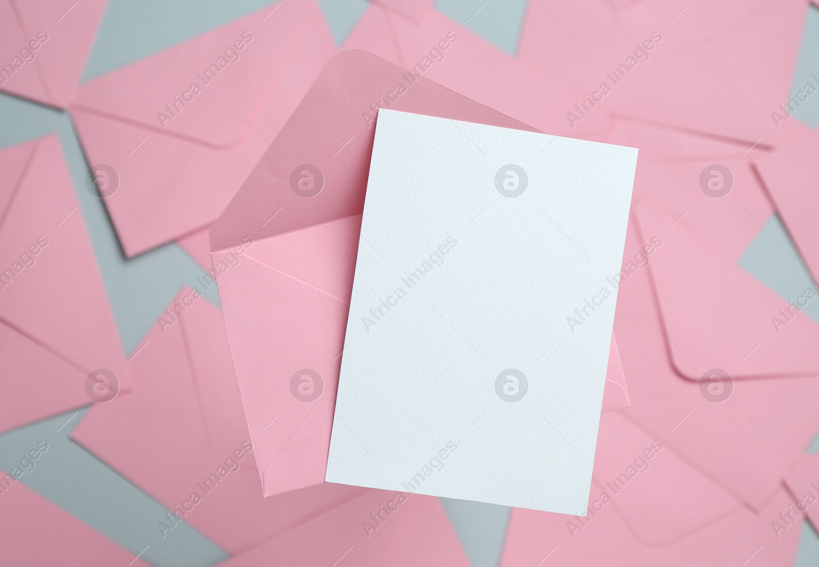 Blank invitation card and envelope on glass surface, top view. Space for design Photo of Blank invitation card and envelope on glass surface, top view. Space for design