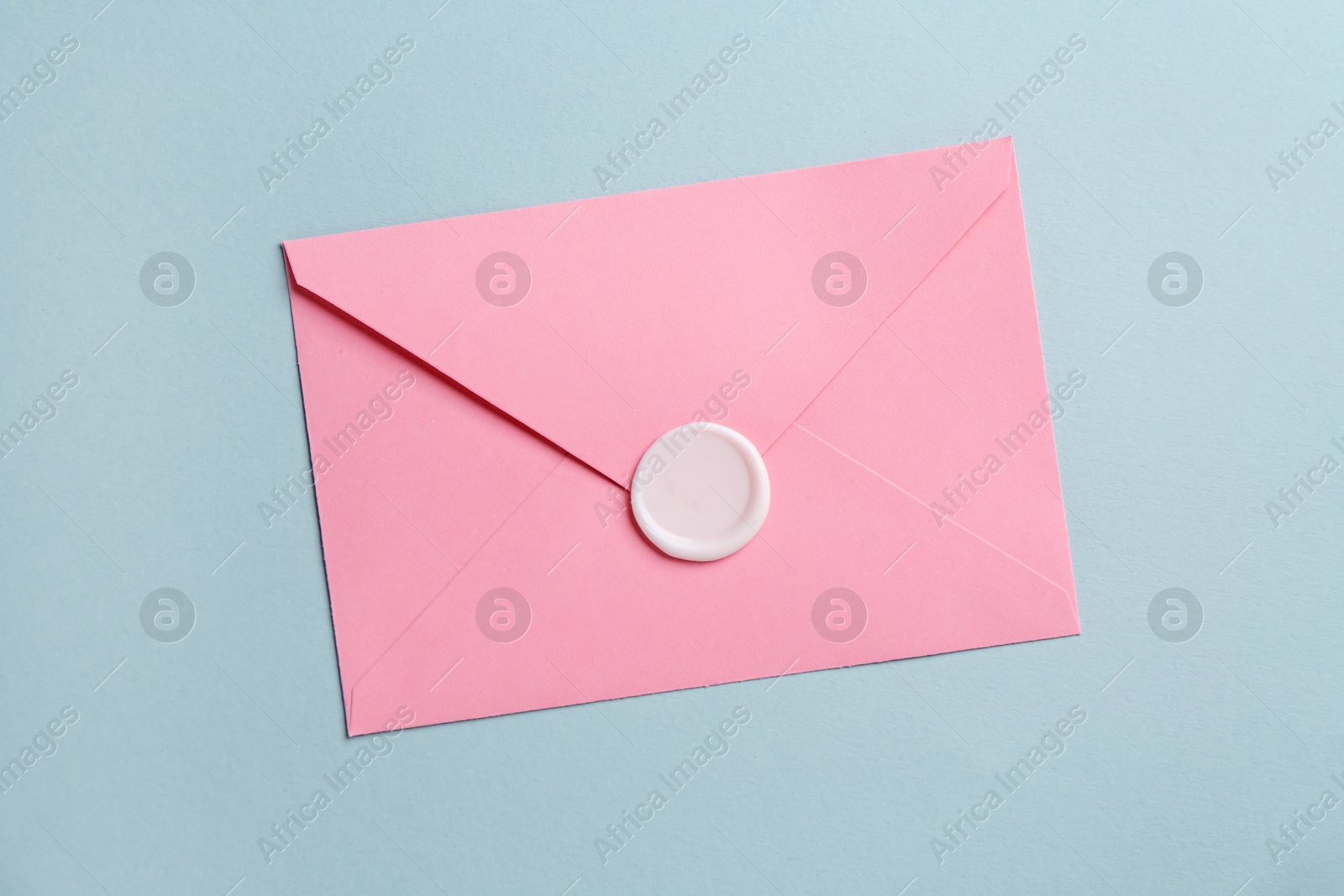 Beautiful invitation envelope with wax seal on grey background, top view Photo of Beautiful invitation envelope with wax seal on grey background, top view