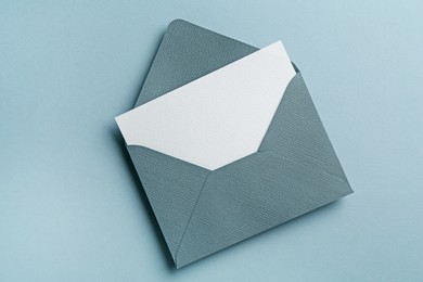 Photo of Blank invitation card and envelope on grey background, top view