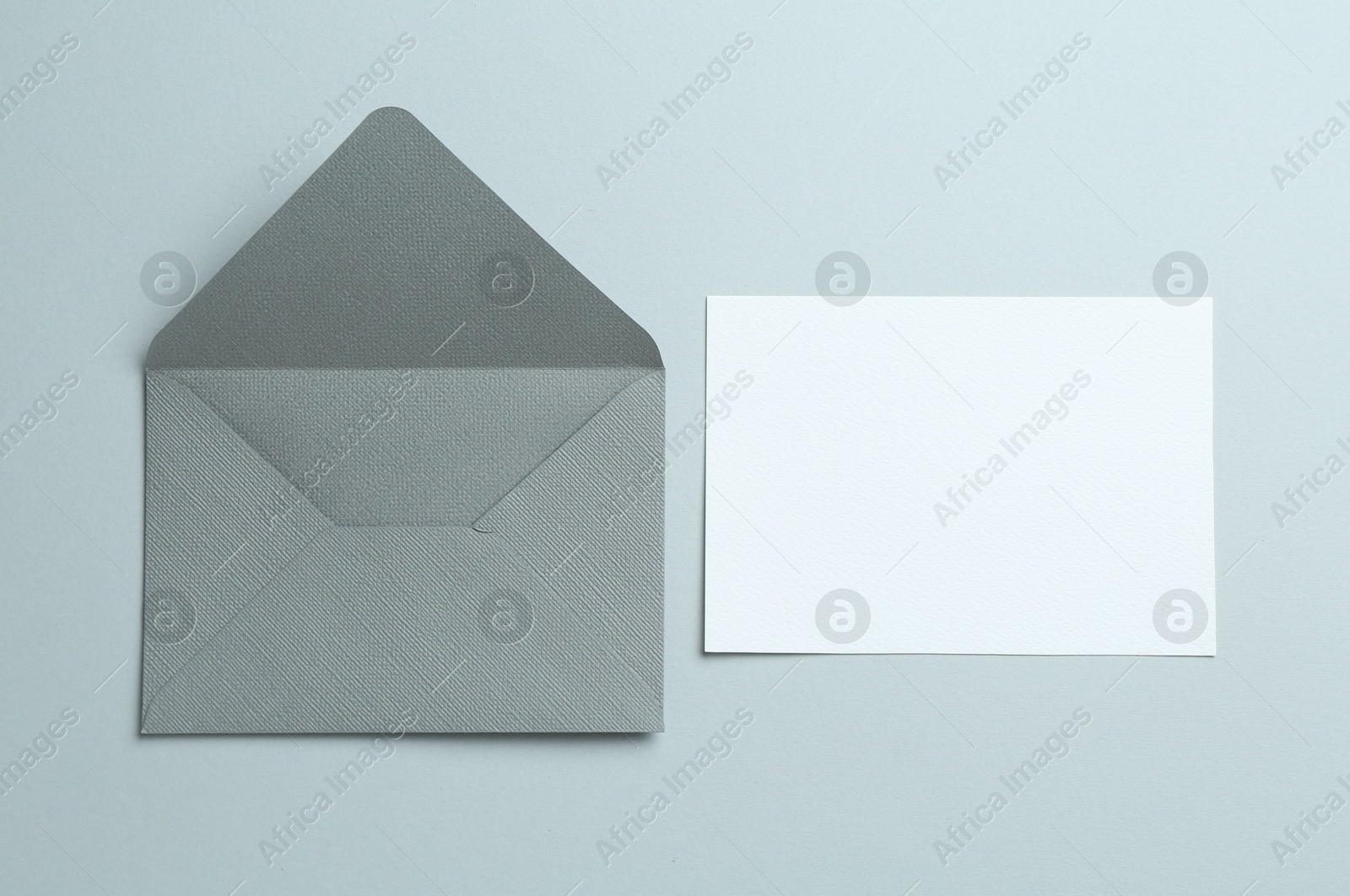 Blank invitation card and envelope on grey background, flat lay. Space for design Photo of Blank invitation card and envelope on grey background, flat lay. Space for design