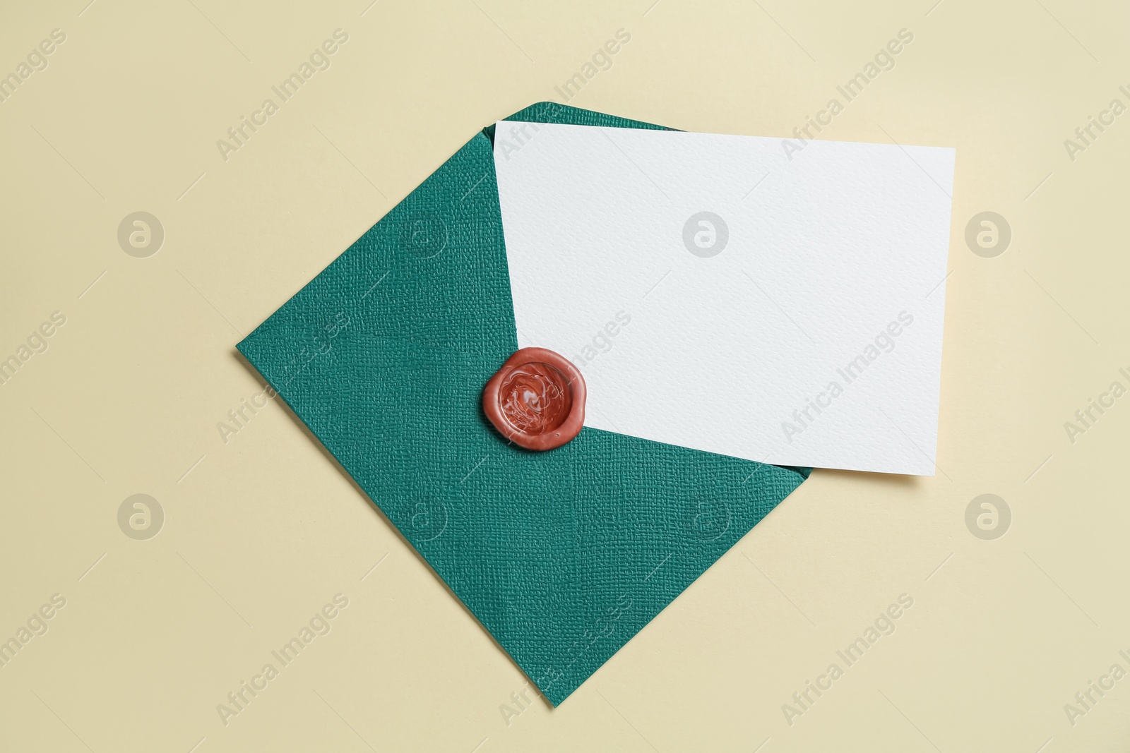 Blank invitation card and envelope on beige background, top view. Space for design Photo of Blank invitation card and envelope on beige background, top view. Space for design