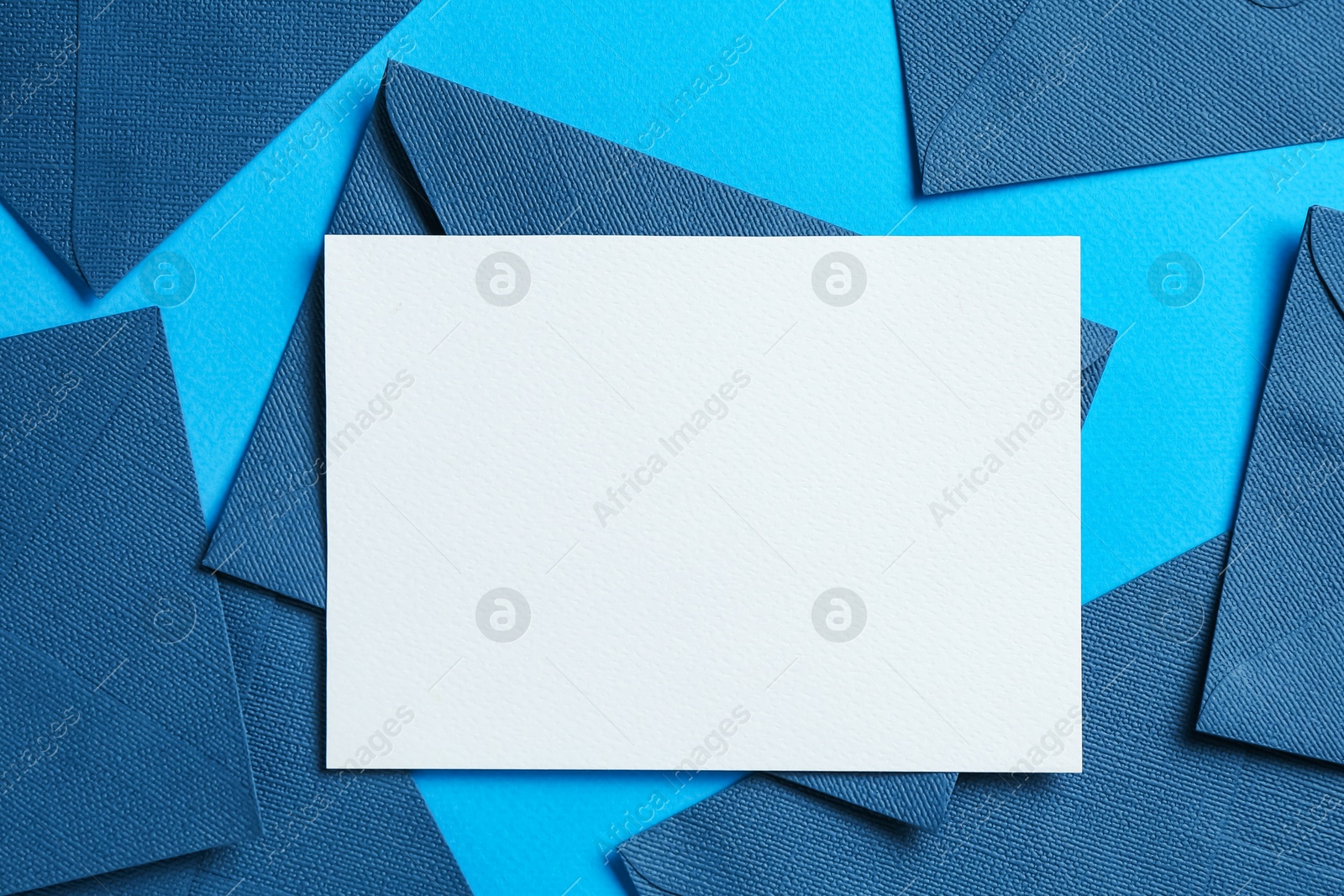 Blank invitation card and envelopes on light blue background, flat lay. Space for design Photo of Blank invitation card and envelopes on light blue background, flat lay. Space for design