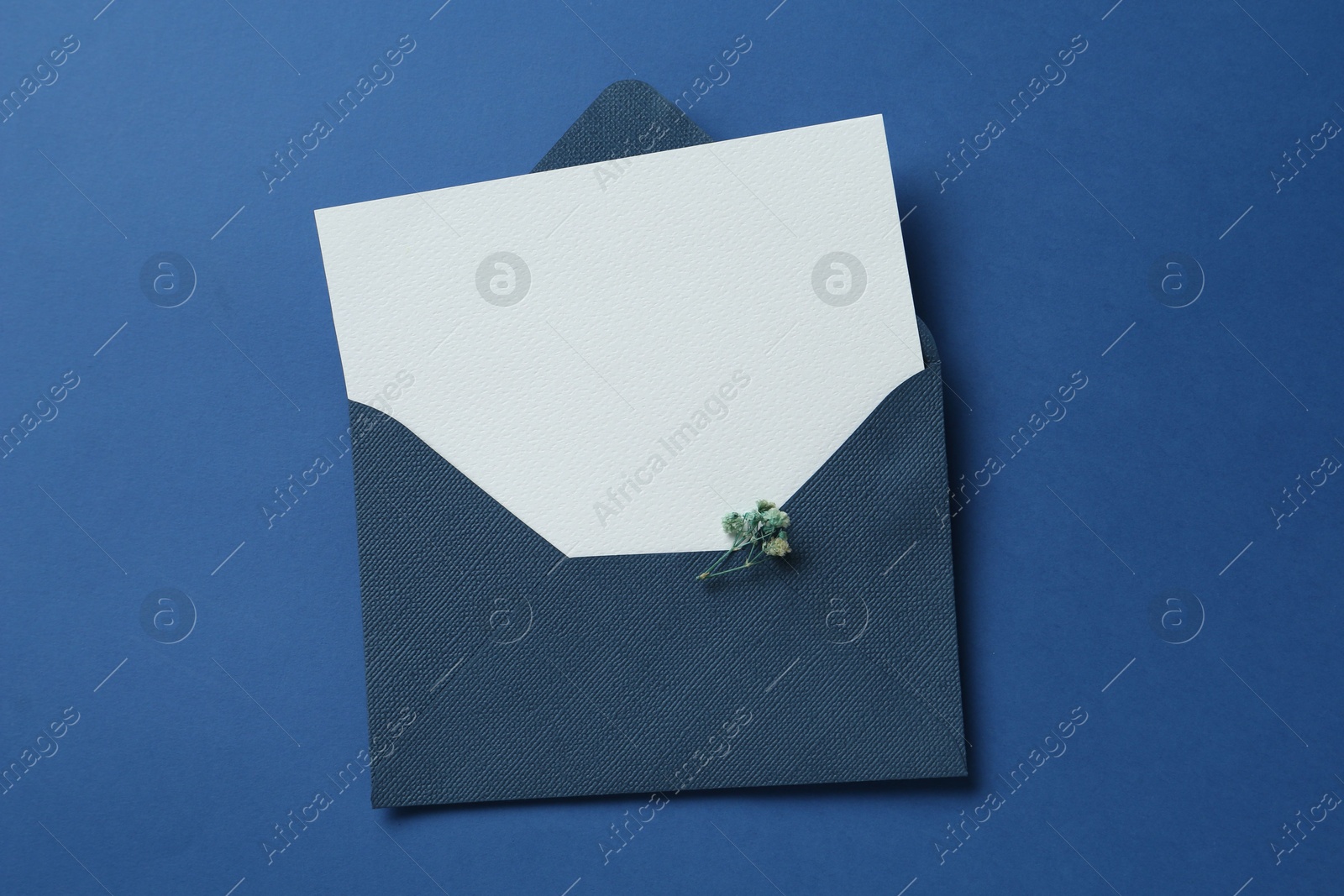 Blank invitation card and envelope on blue background, top view. Space for design Photo of Blank invitation card and envelope on blue background, top view. Space for design