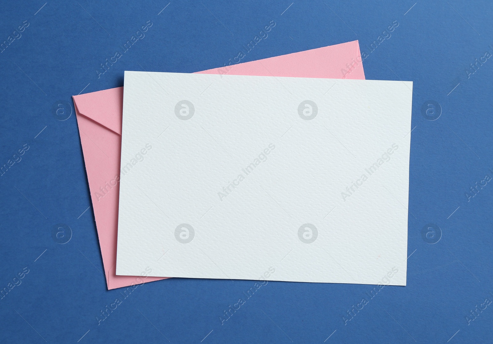 Blank invitation card and envelope on blue background, top view. Space for design Photo of Blank invitation card and envelope on blue background, top view. Space for design