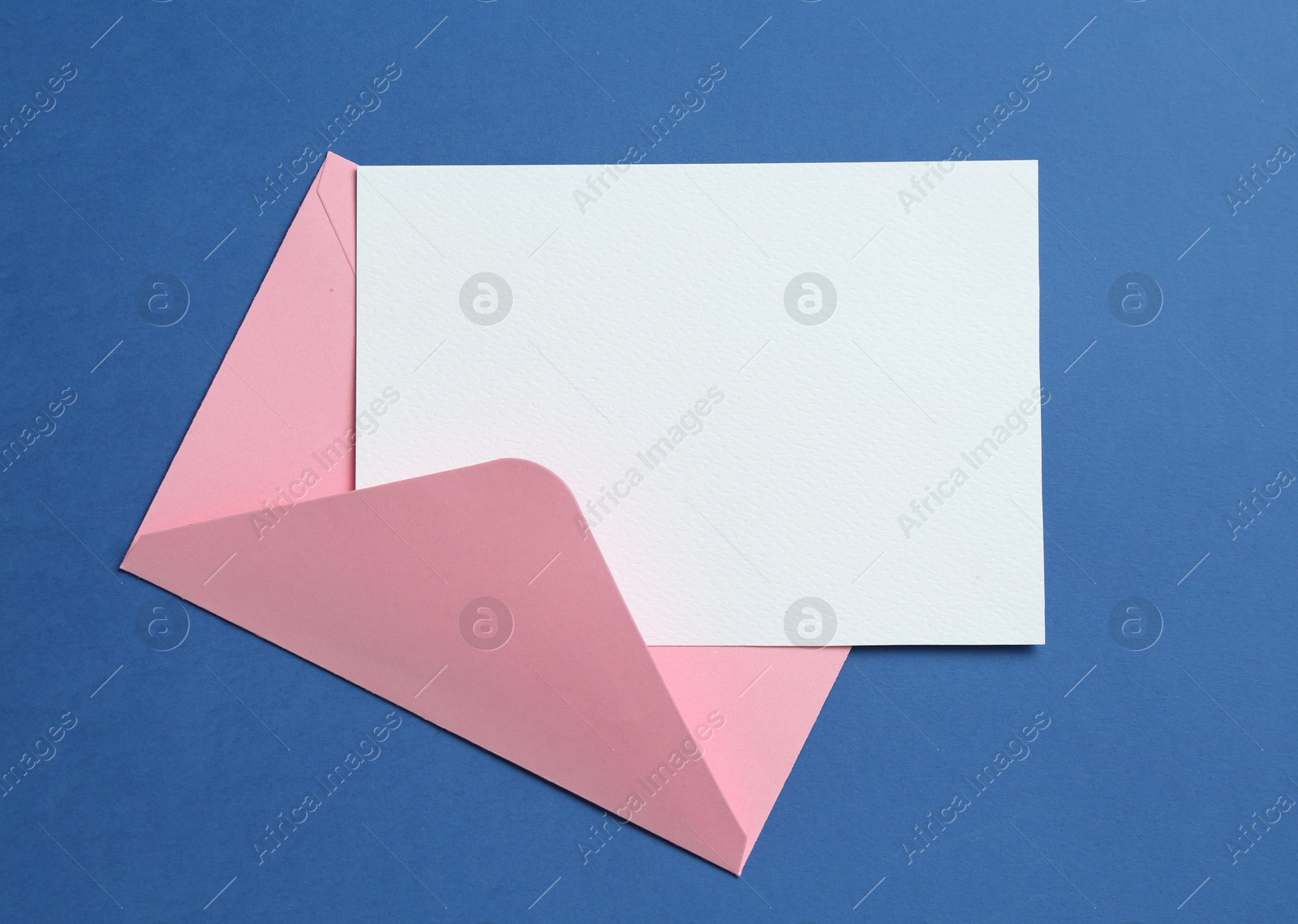 Blank invitation card and envelope on blue background, top view. Space for design Photo of Blank invitation card and envelope on blue background, top view. Space for design
