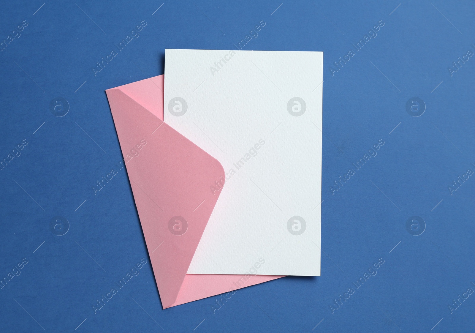 Blank invitation card and envelope on blue background, top view. Space for design Photo of Blank invitation card and envelope on blue background, top view. Space for design
