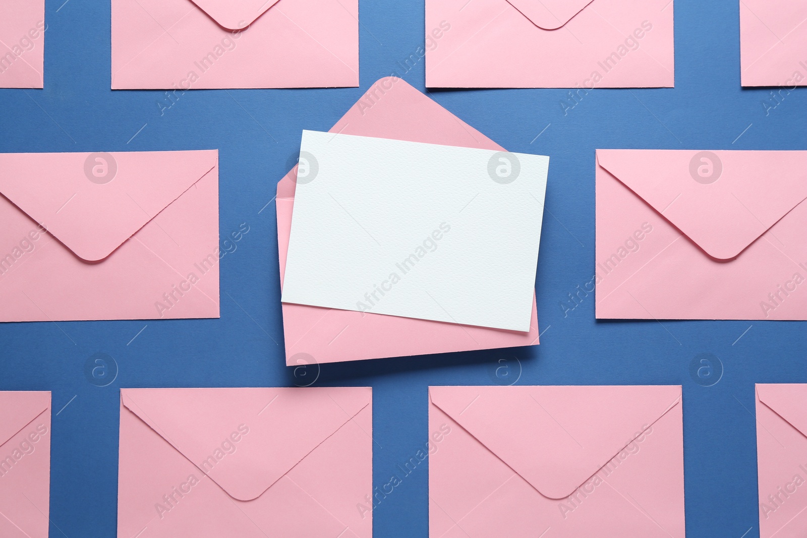 Blank invitation card and envelopes on blue background, flat lay. Space for design Photo of Blank invitation card and envelopes on blue background, flat lay. Space for design