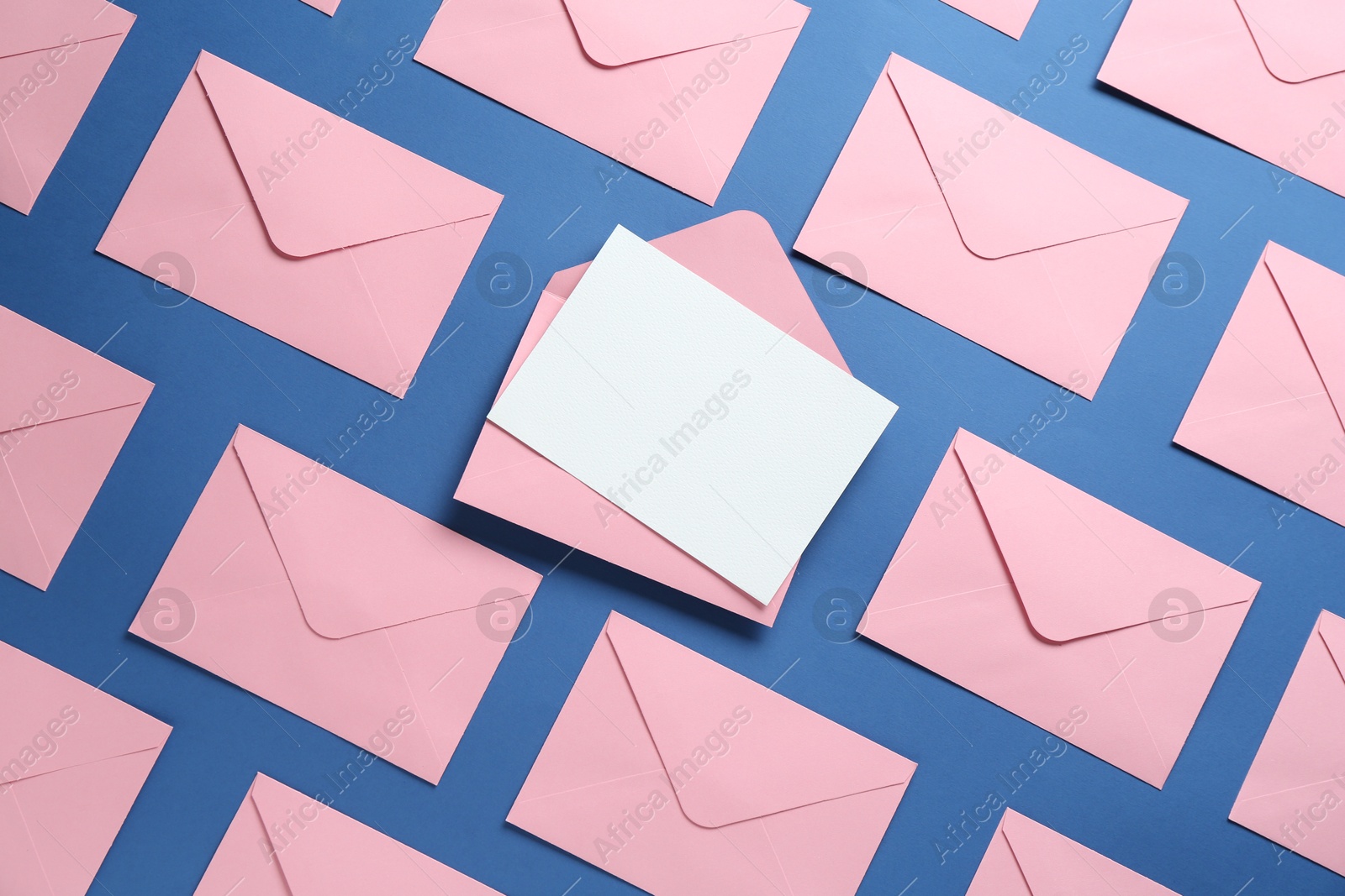 Blank invitation card and envelopes on blue background, flat lay. Space for design Photo of Blank invitation card and envelopes on blue background, flat lay. Space for design