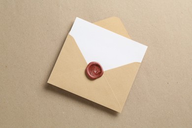 Photo of Blank invitation card and envelope on carton, top view. Space for design