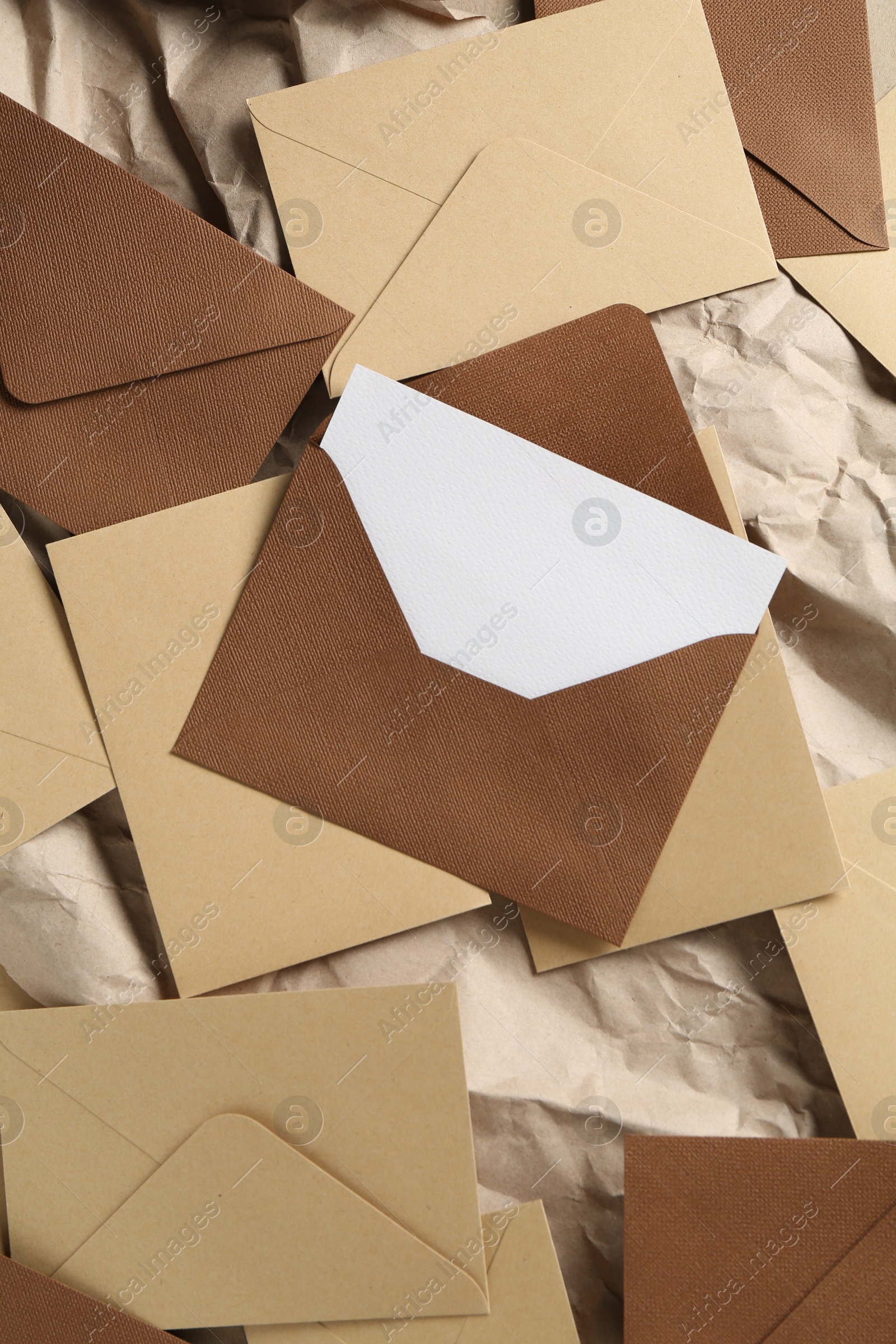 Blank invitation card and envelopes on parchment paper, flat lay Photo of Blank invitation card and envelopes on parchment paper, flat lay