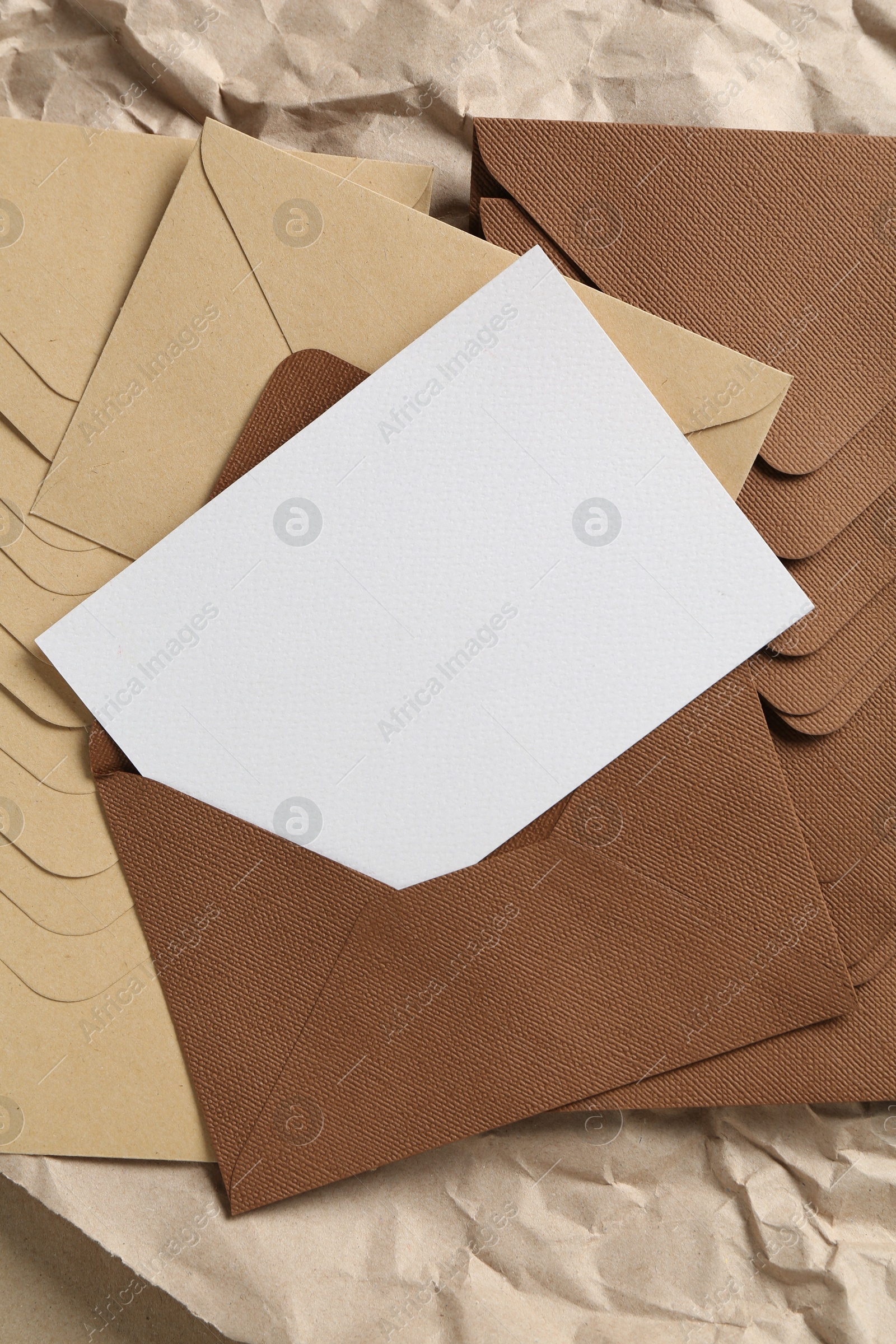 Blank invitation card, envelopes and parchment paper on table, top view. Space for design Photo of Blank invitation card, envelopes and parchment paper on table, top view. Space for design