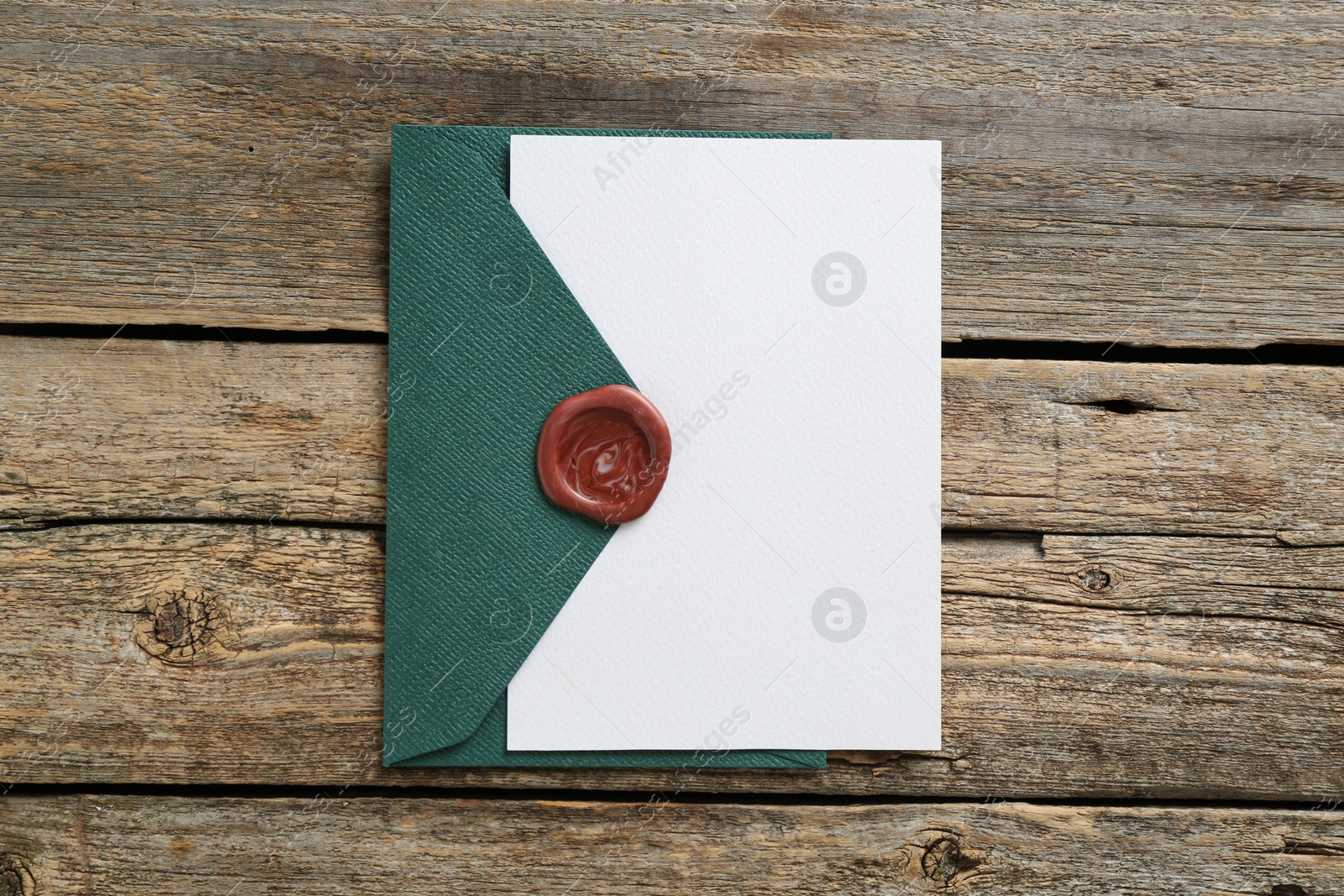 Blank invitation card and envelope on wooden table, top view. Space for design Photo of Blank invitation card and envelope on wooden table, top view. Space for design
