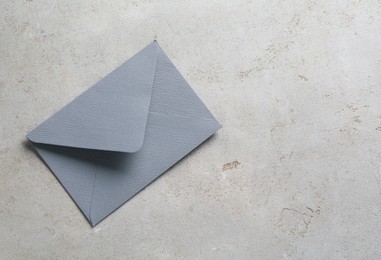Photo of Beautiful invitation envelope on light grey table, top view. Space for text
