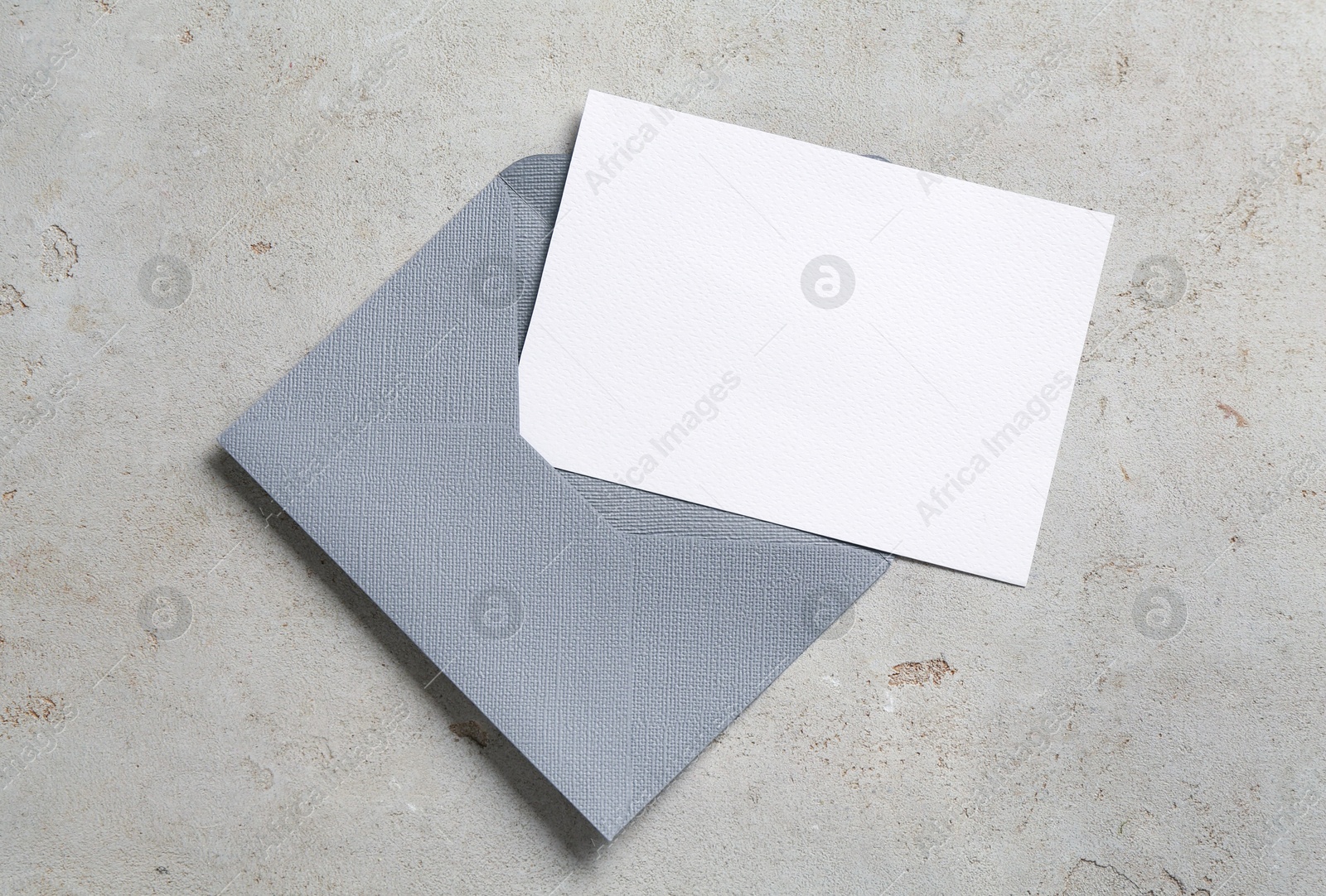 Blank invitation card and envelope on light grey table, top view. Space for design Photo of Blank invitation card and envelope on light grey table, top view. Space for design